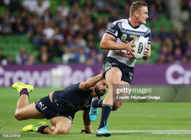 Jesse Bromwich of the Storm tackles Coen Hess of the Cowboys during the round three NRL match between the Melbourne Storm and the North Queensland...