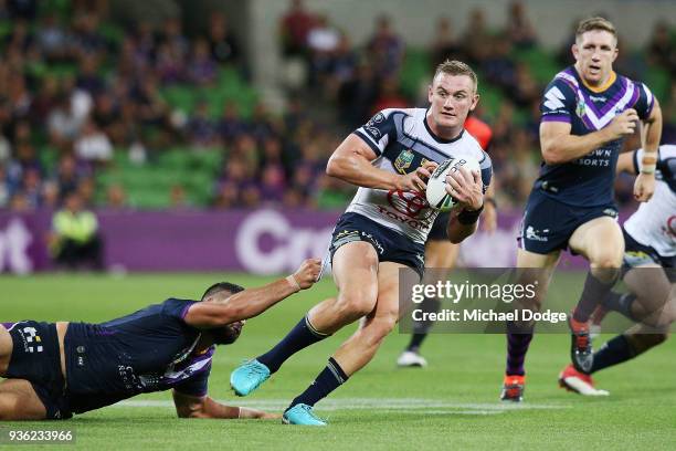 Jesse Bromwich of the Storm tackles Coen Hess of the Cowboys during the round three NRL match between the Melbourne Storm and the North Queensland...