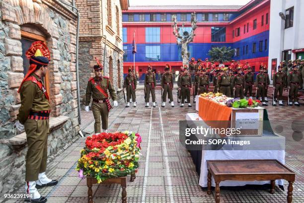 Jammu and Kashmir policemen stand in formation during a wreath laying ceremony of their dead colleague in Srinagar. Five suspected militants and Five...