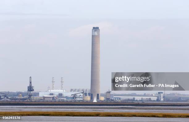Sailing boat passes the the chimney stack at Uniper's decommissioned, Kingsnorth Power Station, in Hoo, Rochester, Kent, which stands at twice the...
