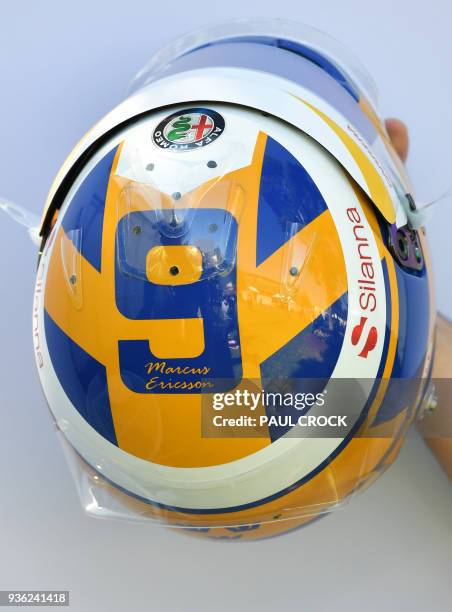 The helmet of Sauber's Swedish driver Marcus Ericsson is displayd ahead of the Formula One Australian Grand Prix in Melbourne on March 22, 2018. /...