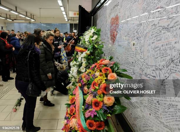 People write messages and place flower on the memorial wall as they mark the second anniversary of the 2016 terrorist attacks in Brussels, at...