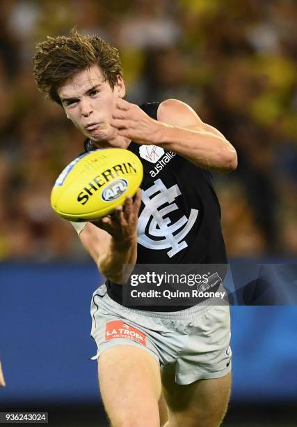 Paddy Dow of the Blues handballs during the round one AFL match between the Richmond Tigers and the Carlton Blues at Melbourne Cricket Ground on...