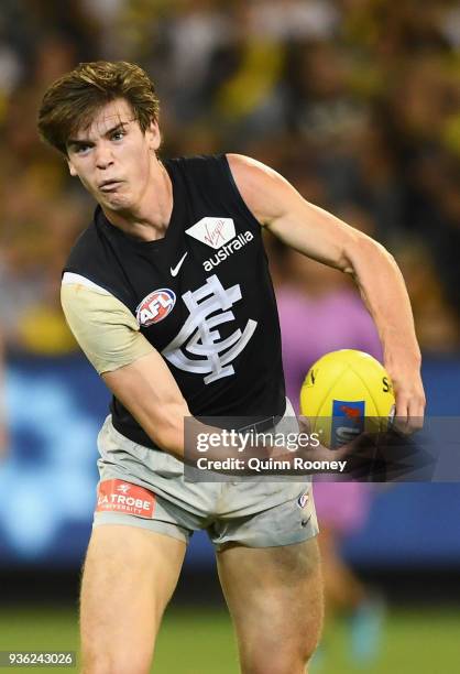 Paddy Dow of the Blues handballs during the round one AFL match between the Richmond Tigers and the Carlton Blues at Melbourne Cricket Ground on...