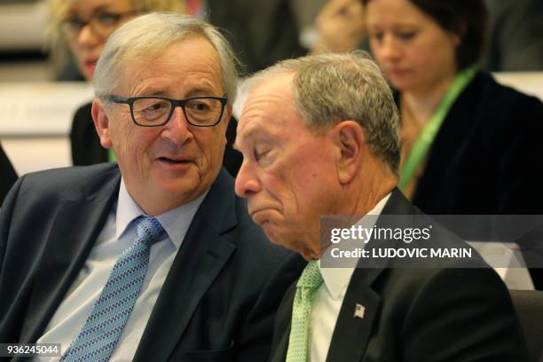 European Commission president Jean-Claude Juncker speaks with United Nations Secretary-general envoy for climate action Michael Bloomberg during the...