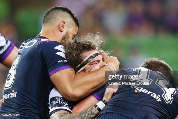 Jesse Bromwich of the Storm tackles Ethan Lowe of the Cowboys during the round three NRL match between the Melbourne Storm and the North Queensland...