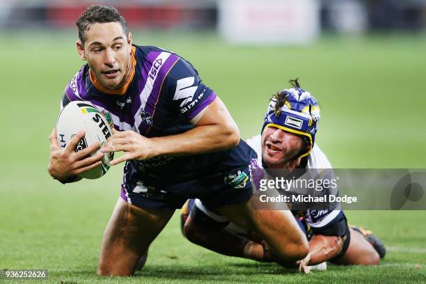 Johnathan Thurston of the Cowboys tackles Billy Slater of the Storm during the round three NRL match between the Melbourne Storm and the North...