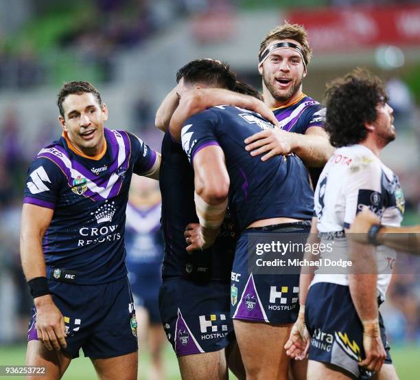 Jake Granville of the Cowboys reacts as Billy Slater and Christian Welch of the Storm celebrate a try during the round three NRL match between the...