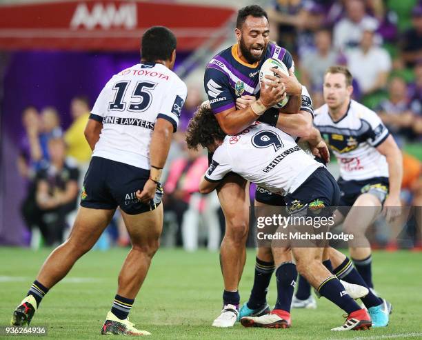 Sam Kasiano of the Storm is tackled by Jake Granville of the Cowboys during the round three NRL match between the Melbourne Storm and the North...