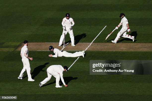 Tom Latham of New Zealand gets to his crease as England stumble on the ball during day one of the First Test match between New Zealand and England at...