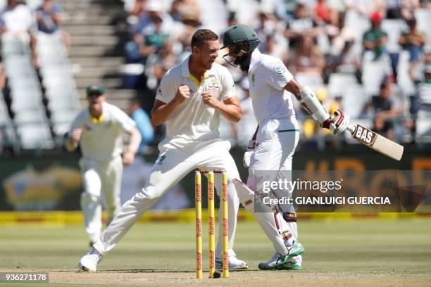 Australian bowler Josh Hazlewood celebrates the dismissal of South African batsman Hashim Amla during the first day of the third Test cricket match...