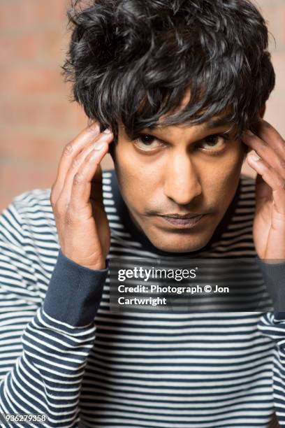 man with fingers on his temples looking at the camera - mind reading stock pictures, royalty-free photos & images