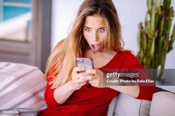 woman feeling big surprise checking phone - mobile bad news stock pictures, royalty-free photos & images