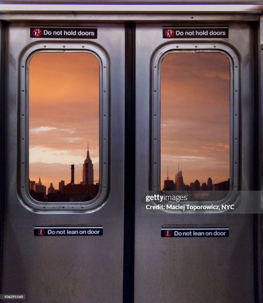 View of Manhattan skyline through a subway window