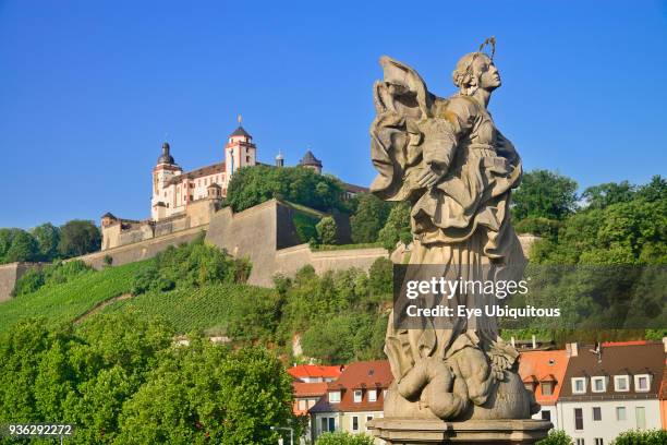 Germany, Bavaria, Wurzburg, Festung Marienberg above the River Main with a statue of St Marie or Mary Patron saint of Franconia.