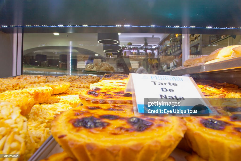 Portugal, Estremadura, Lisbon, Baixa, Display of custard cakes and pastries.