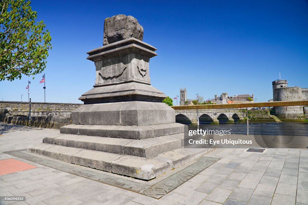 Ireland, County Limerick, Limerick City, The Treaty Stone with the River Shannon and St John's Castle.