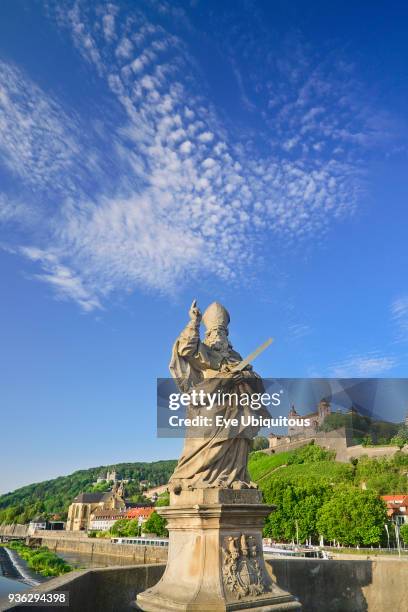 Germany, Bavaria, Wurzburg, Festung Marienberg fortress above the River Main with a statue of St Kilian on Alte Mainbrucke.