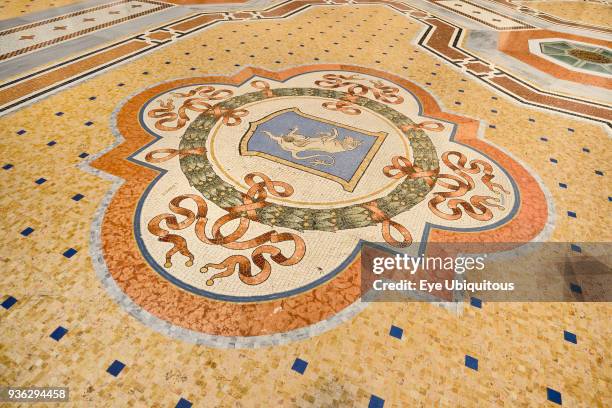 Italy, Lombardy, Milan. Galleria Vittorio Emanuele, Famous bull mosaic on the floor where tradition says that if a person spins around three times...