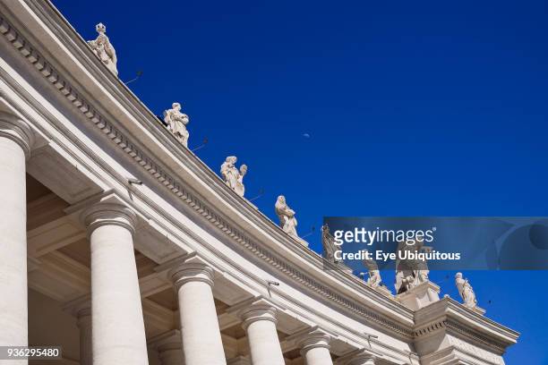 Italy, Vatican City, Statues on the sweeping colonnade by Bernini that circles Piazza San Pietro or St Peters Square.