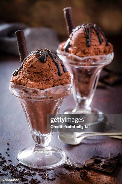 two chocolate ice cream sundae cups - fudge sauce stock pictures, royalty-free photos & images