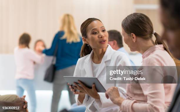 female doctor talking to female patient - synchronisation stock pictures, royalty-free photos & images