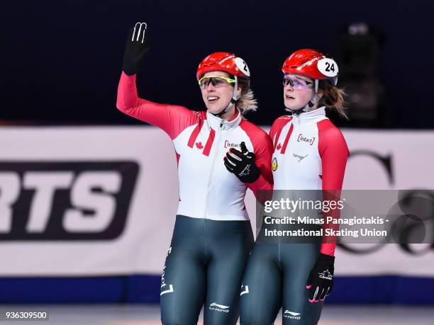 Marianne St-Gelais of Canada waves to the fans as teammate Kim Boutin of Canada stands beside her in the women's 1000 semifinal during the World...