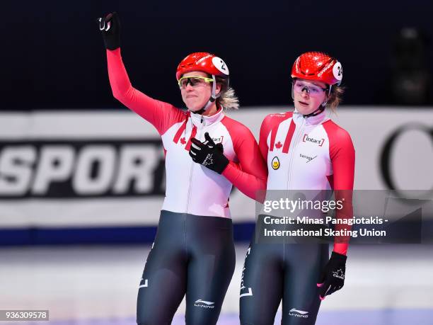 Marianne St-Gelais of Canada waves to the fans as teammate Kim Boutin of Canada stands beside her in the women's 1000 semifinal during the World...