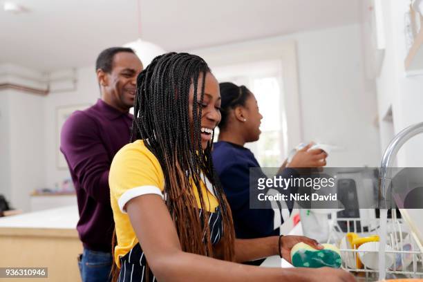 two teenage girls (12-13, 14-15) washing dishes - family cleaning stock pictures, royalty-free photos & images