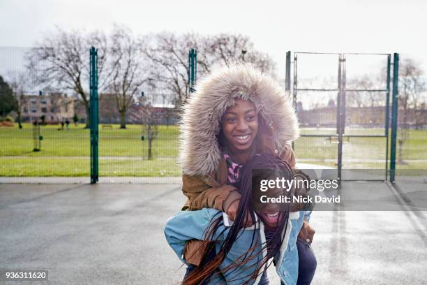 two teenager girls (12-13, 14-15) playing in park - friends messing about stock pictures, royalty-free photos & images