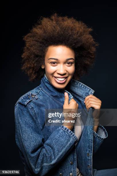 happy woman with frizzy hair holding denim jacket - frizzy stock pictures, royalty-free photos & images