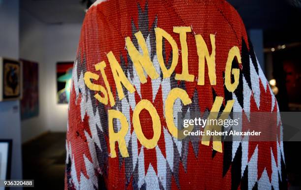 Coat made from an antique blanket for sale in a Santa Fe, New Mexico, art gallery is embellished with cutout letters spelling 'Standing Rock',...