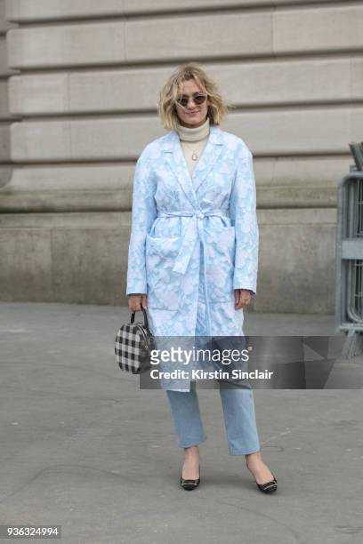 Fashion blogger of adenorah, Anne-Laure Mais wears a Rochas coat, Roger Vivier shoes and vintage jeans and sunglasses day 3 of Paris Womens Fashion...