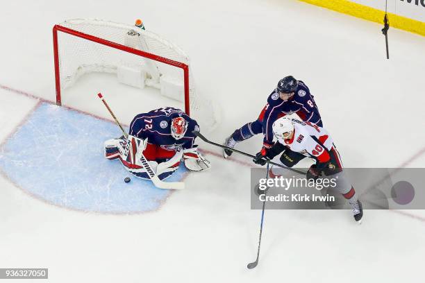 Zach Werenski of the Columbus Blue Jackets defends as Sergei Bobrovsky of the Columbus Blue Jackets stops a shot from Jim O'Brien of the Ottawa...
