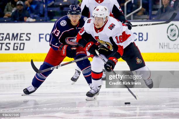 Ryan Dzingel of the Ottawa Senators skates the puck away from Cam Atkinson of the Columbus Blue Jackets during the game on March 17, 2018 at...