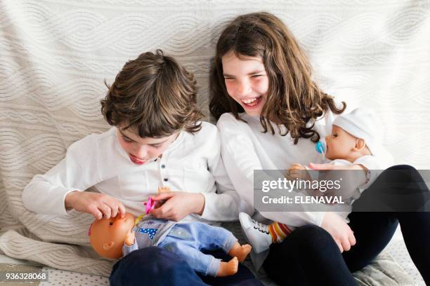 boy and girl playing with dolls - doll foto e immagini stock