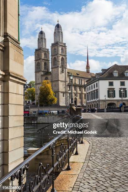 beautiful view of grossmünster church from across the limmat river in zurich - grossmünster stock-fotos und bilder
