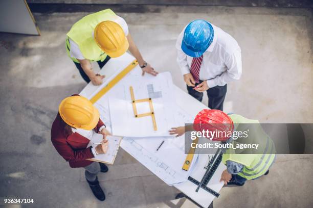 construction workers checking the progress - 2018 blueprint stock pictures, royalty-free photos & images