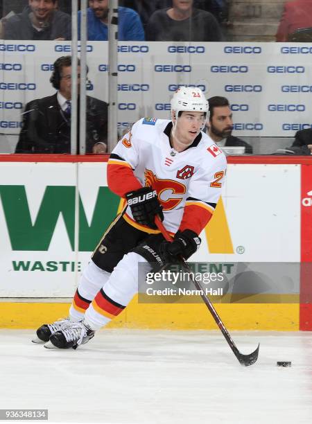 Sean Monahan of the Calgary Flames skates with the puck against the Arizona Coyotes at Gila River Arena on March 19, 2018 in Glendale, Arizona.