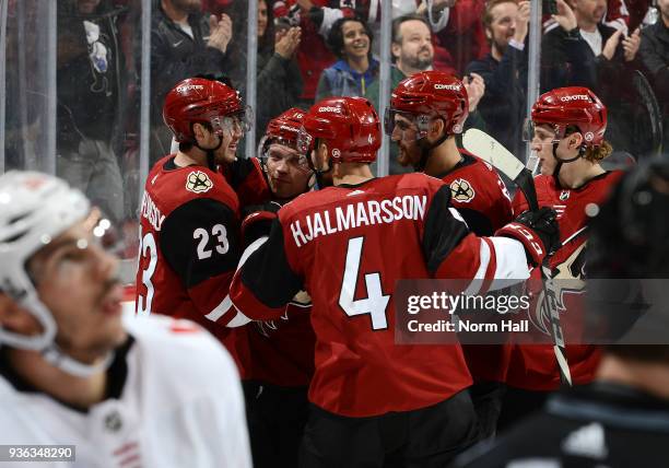 Oliver Ekman-Larsson of the Arizona Coyotes celebrates with teammates Max Domi, Niklas Hjalmarsson, Brendan Perlini and Christian Dvorak after...