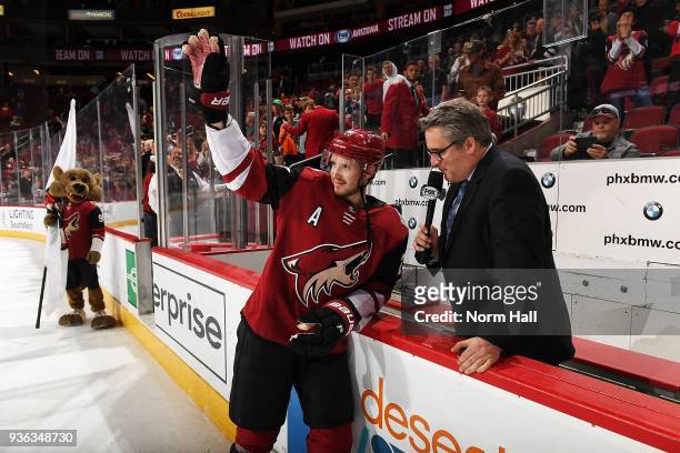 Oliver Ekman-Larsson of the Arizona Coyotes waves to the crowd after being named first star of the game against the Calgary Flames at Gila River...
