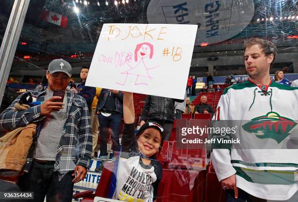 Young Vancouver Canucks fan holds up a sign for Jake Virtanen of the Vancouver Canucks during their NHL game against the Minnesota Wild at Rogers...