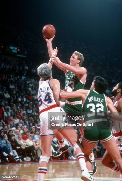 Larry Bird of the Boston Celtics shoots over Tom McMillen of the Washington Bullets during an NBA basketball game circa 1985 at the Capital Center in...