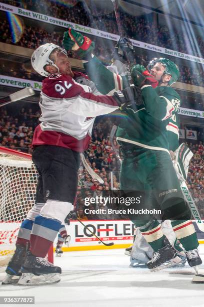 Nate Prosser of the Minnesota Wild and Gabriel Landeskog of the Colorado Avalanche are both called for roughing penalties during the game at the Xcel...
