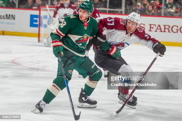 Tyler Ennis of the Minnesota Wild defends J.T. Compher of the Colorado Avalanche during the game at the Xcel Energy Center on March 13, 2018 in St....