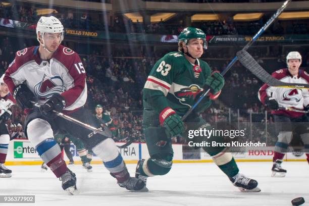 Tyler Ennis of the Minnesota Wild and Duncan Siemens of the Colorado Avalanche skate to the puck during the game at the Xcel Energy Center on March...