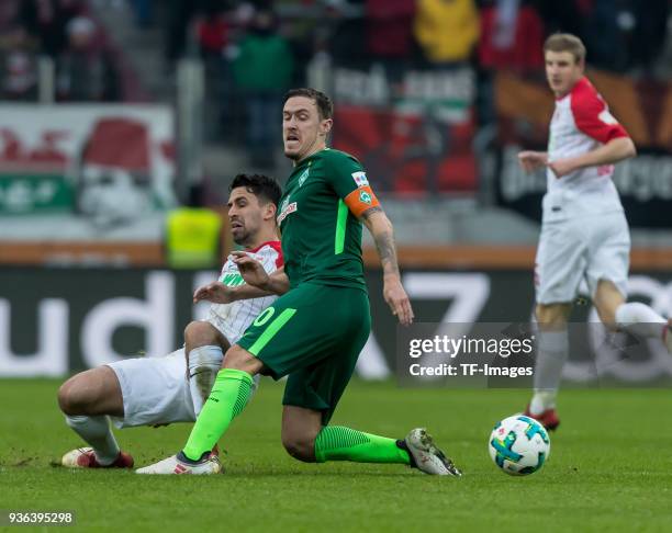 Rani Khedira of Augsburg and Max Kruse of Bremen battle for the ball during the Bundesliga match between FC Augsburg and SV Werder Bremen at...
