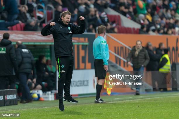 Head coach Florian Kohfeldt of Bremen celebrates after Jesper Verlaat of Bremen scores their team's second goal during the Bundesliga match between...