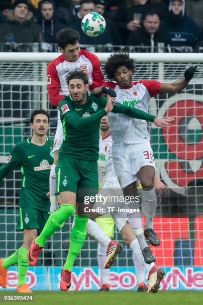 Gojko Kacar of Augsburg Caiuby, Francisco da Silva of Augsburg and Ishak Belfodil of Bremen go for a header during the Bundesliga match between FC...