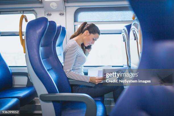 beautiful black hair woman, traveling by the train - train interior stock pictures, royalty-free photos & images